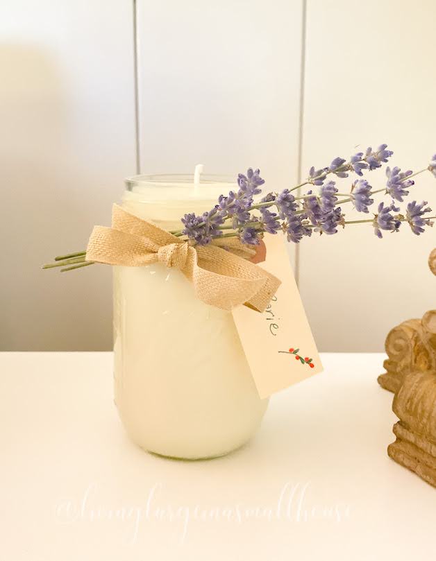 mason jar candle with sprigs of lavender tie d around the neck