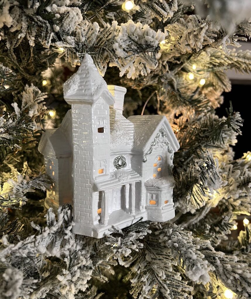 a refreshed house wired on the tree with light glowing through the windows