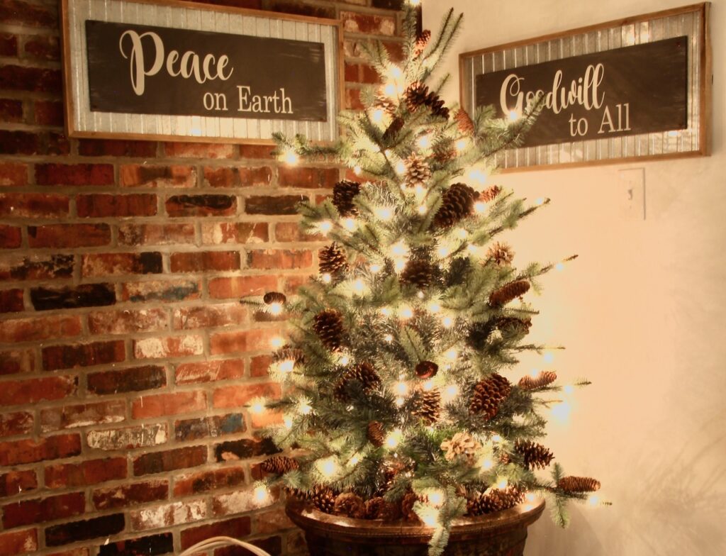 Lit Christmas tree in the corner of a stair landing