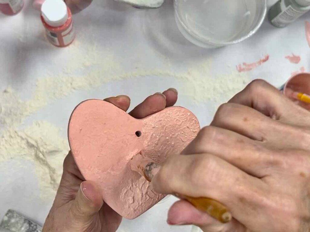 2nd coat of textured paint is being pounced onto the painted clay heart