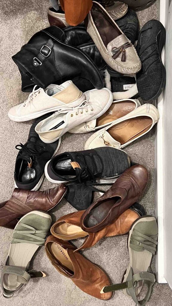 A jumble of women's shoes on a closet floor