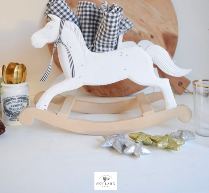 Closeup of a toy rocking. horse made over and holding napkins on a buffet table
