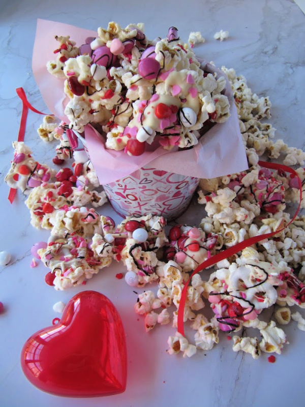 Closeup of popcorn snack mix with valentine candies and white chocolate mixed in