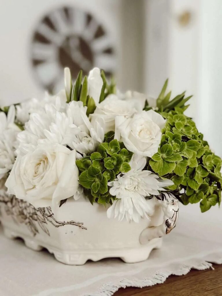 floral arrangement in a vintage soup tureen as a centerpiece