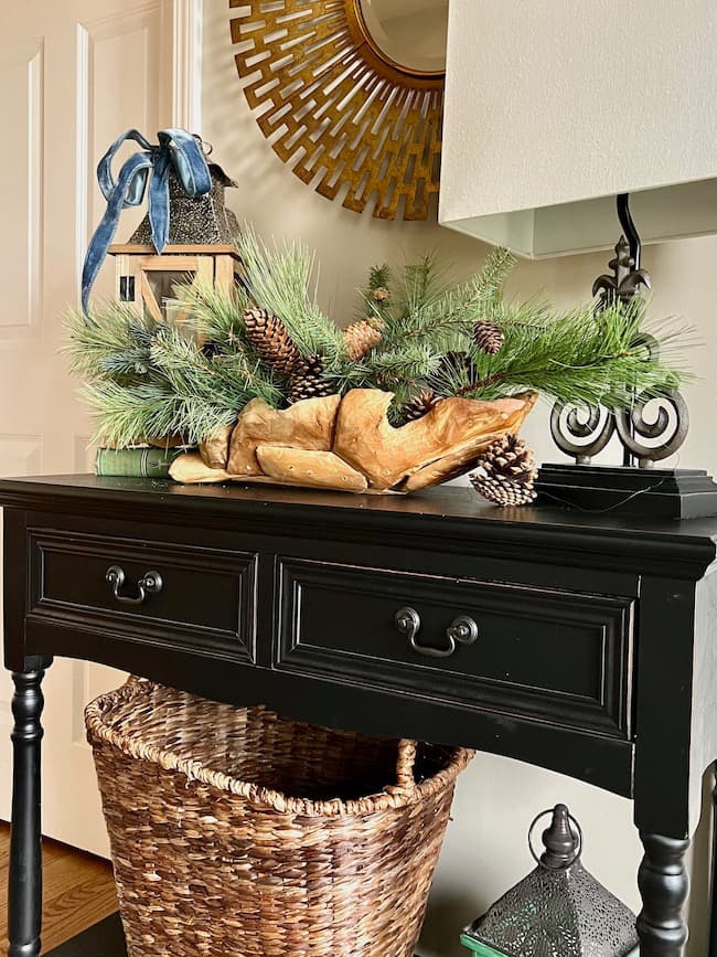 Winter Decor display of pinecones and fir branches in a wood bowl