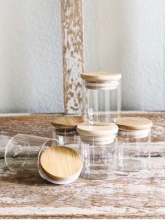 empty glass bottles with cork lids stacked together