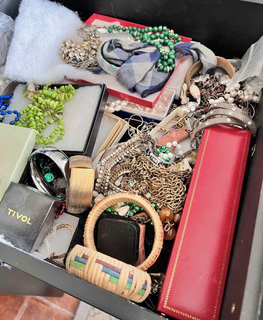 a messy pile of jewelry filling a drawer