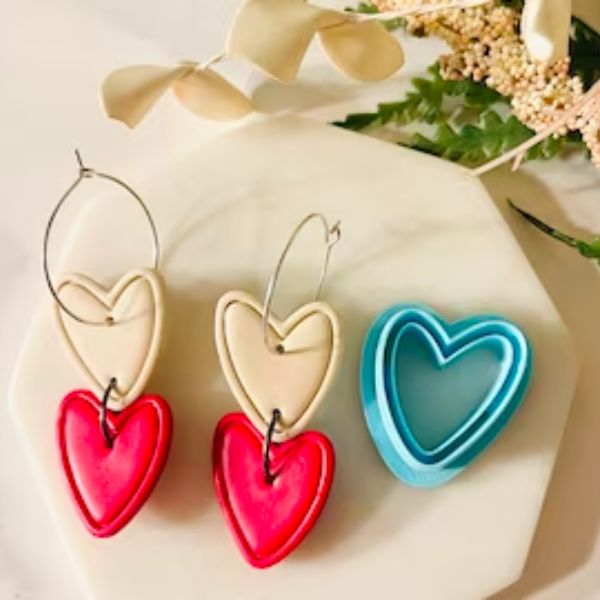 Clay cutter next to earrings made with the cutter