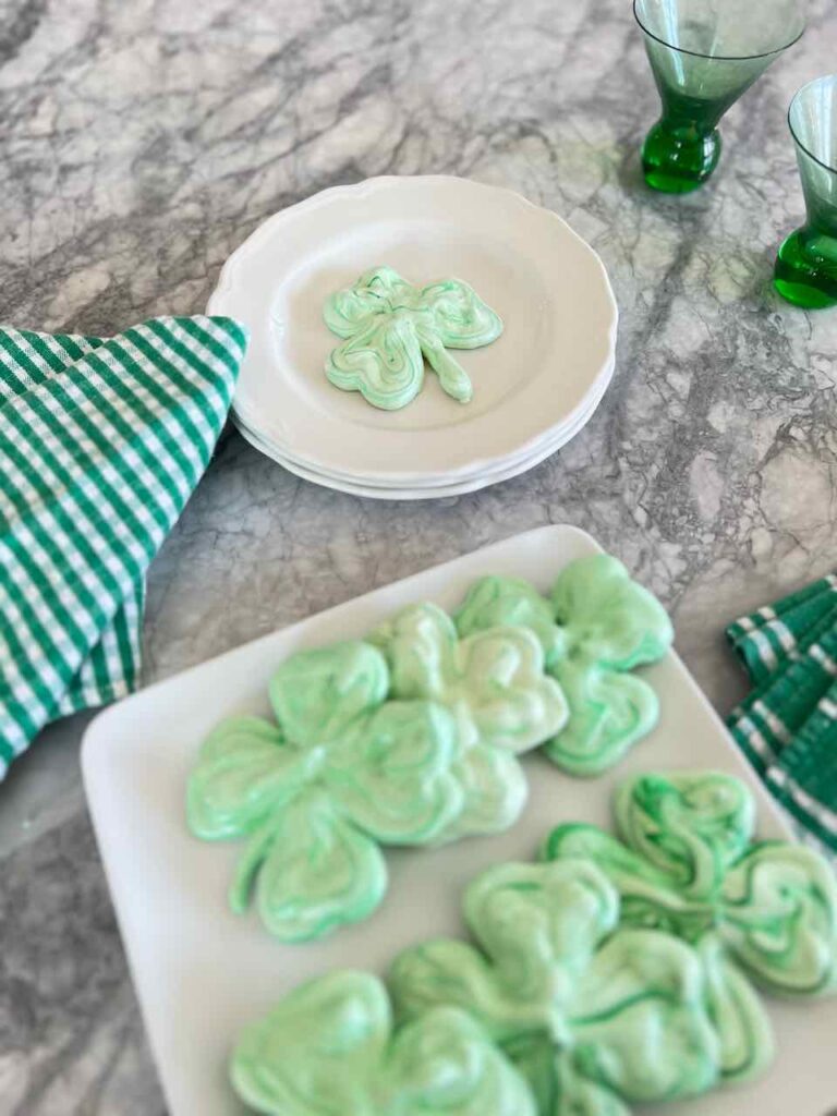 one cookie is on a plate with a napkin and six more cookies are on a serving plate