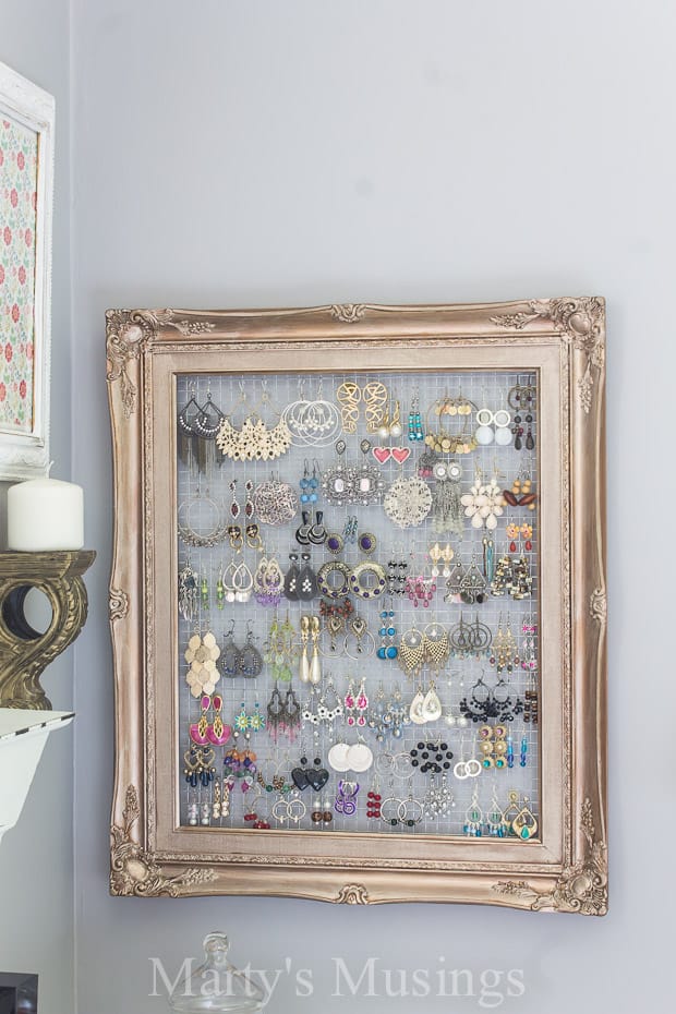 Decorative wire. filling a vintage picture frame with collection of fun jewelry hanging from the wire