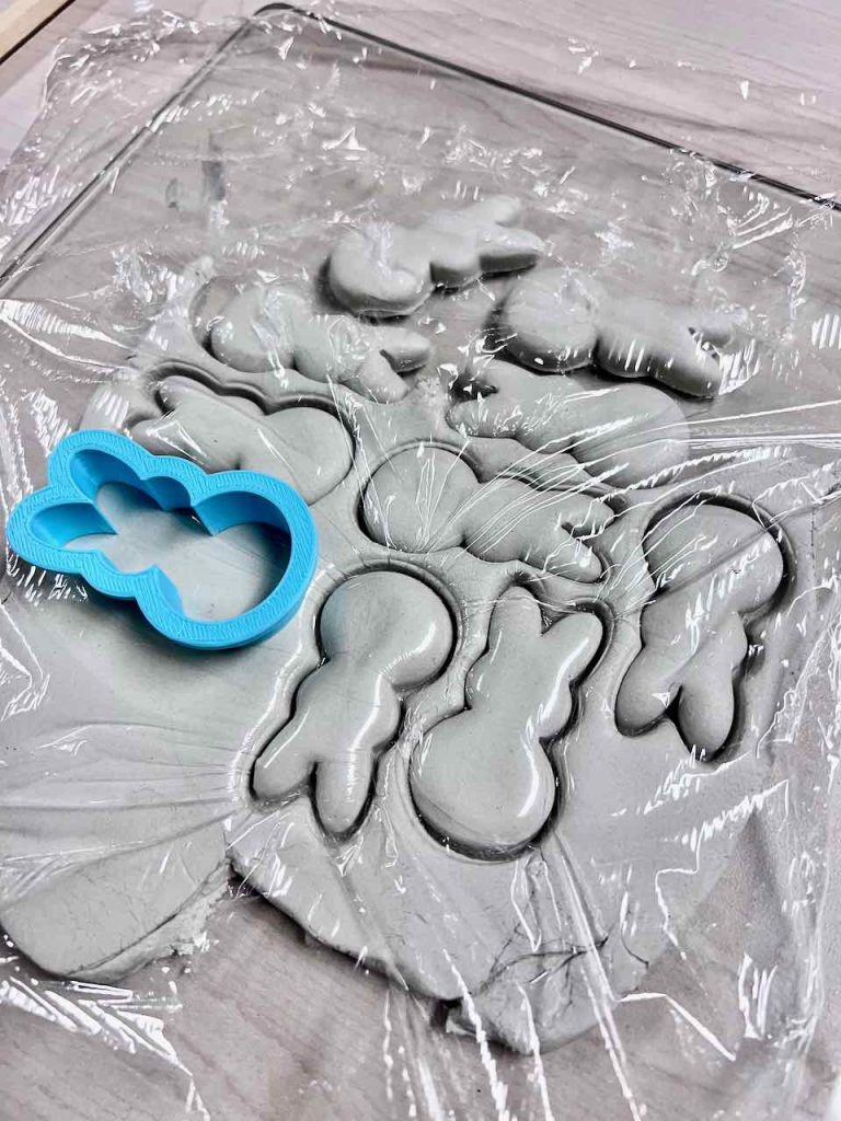 bunny clay cutter is on a piece of plastic wrap on the clay waiting to cut the next bunny