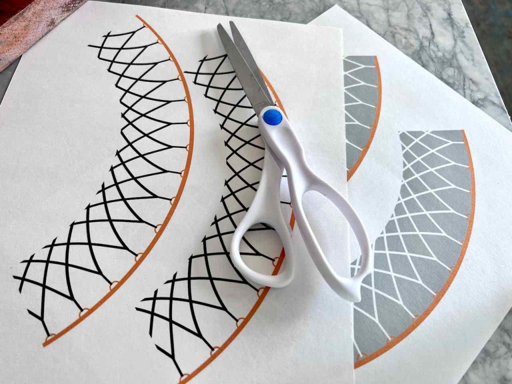two version of cupcake wrappers are shown with a pair of scissors