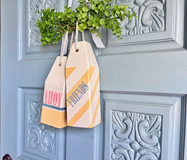 Two buoys that say Ahoy Friends on a blue front door