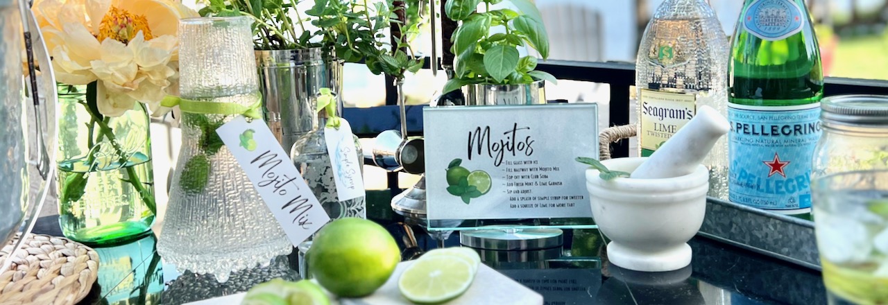 wide closeup of bar cart filled with cocktail making supplies on a patio