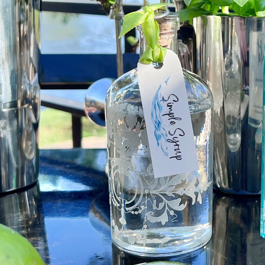 Closeup of a vintage bottle with a tag the reads "Simple Syrup'