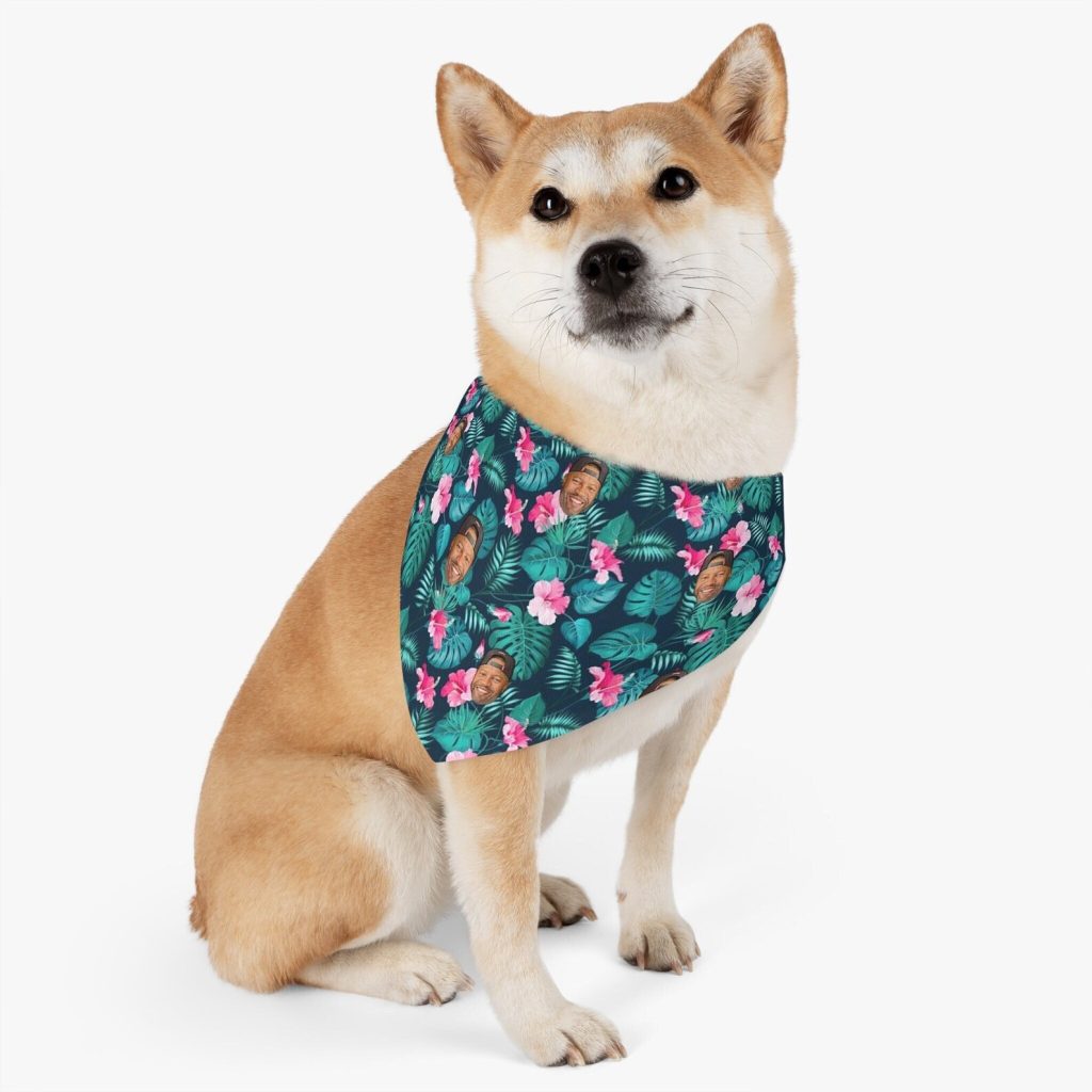 dog wearing a bandana that has a man's face in amongst the flowers