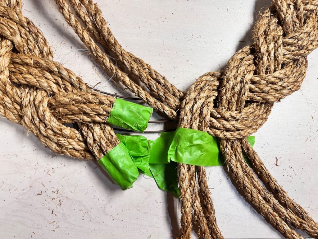 closeup of how to finish the rope braiding on the wreath