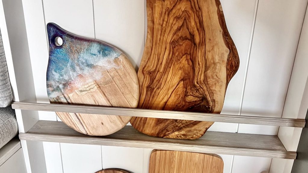 closeup of a shelf and rail holding two cutting boards in the plate rack