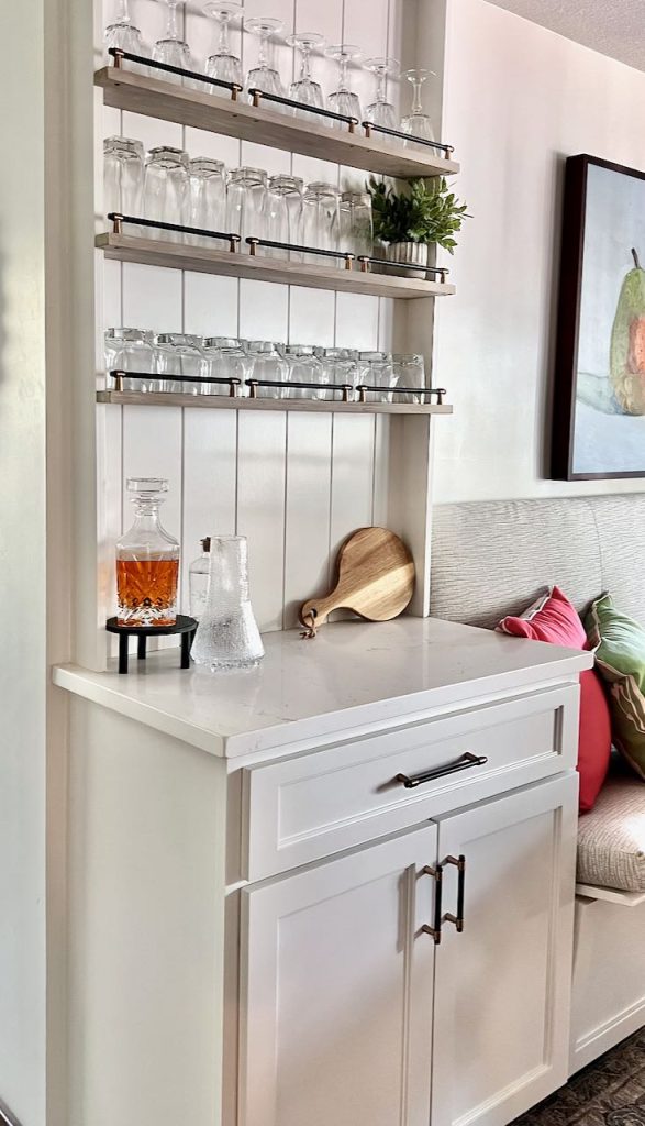 Finished dry bar cabinet with quartz top and shelves for glassware above