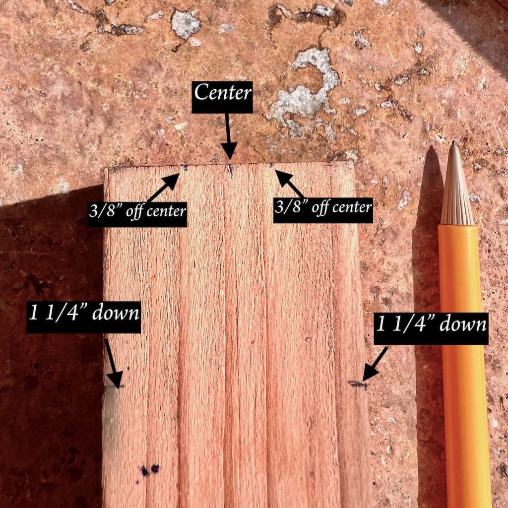 closeup of a small piece of wood with measurement markings