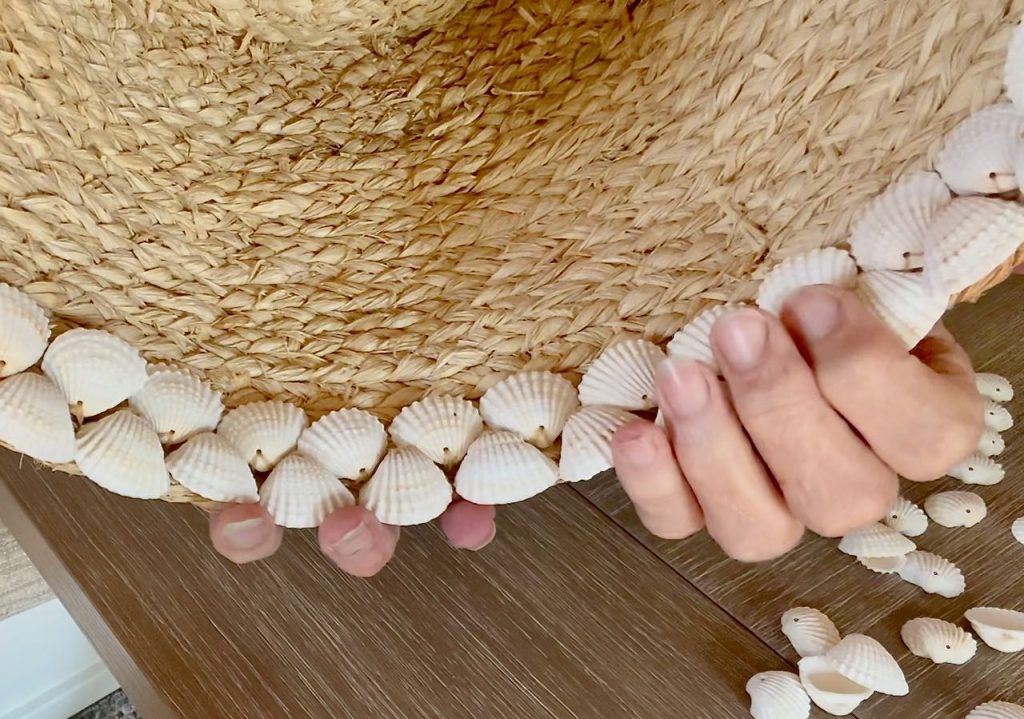 super closeup of stitches and shells along the edge of a basket