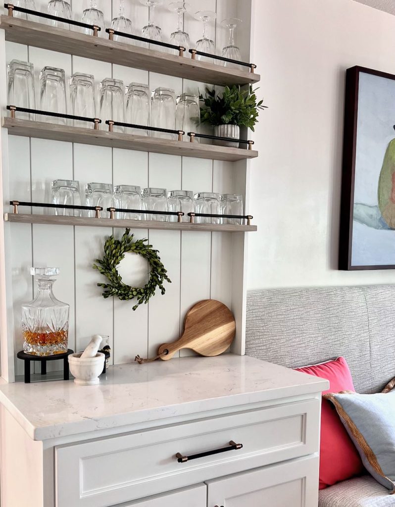 view of the countertop, shiplap and shelves above the cabinet bar