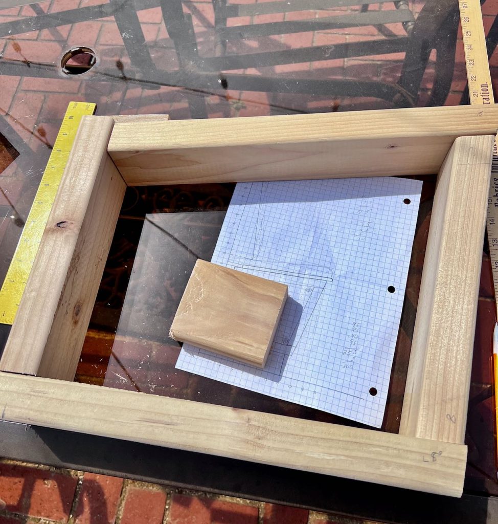 one bench frame is laying down on a glass top outdoor table with the cutting diagram in the center