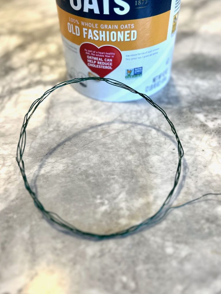 wire wreath form in front of an oatmeal container