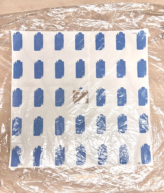 the pattern is taped inside a dry cleaning bag on the work table