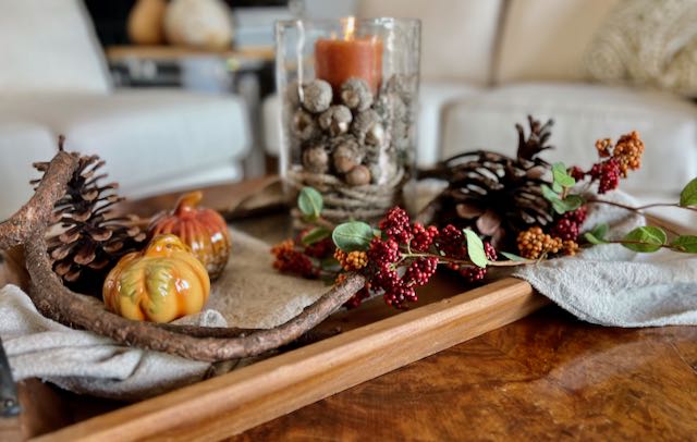 Fall Tray Arrangement With a candle hurricane, pumpkin and acorns