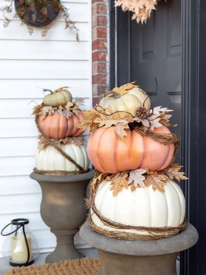side view of two pumpkin topiaries on a front porch