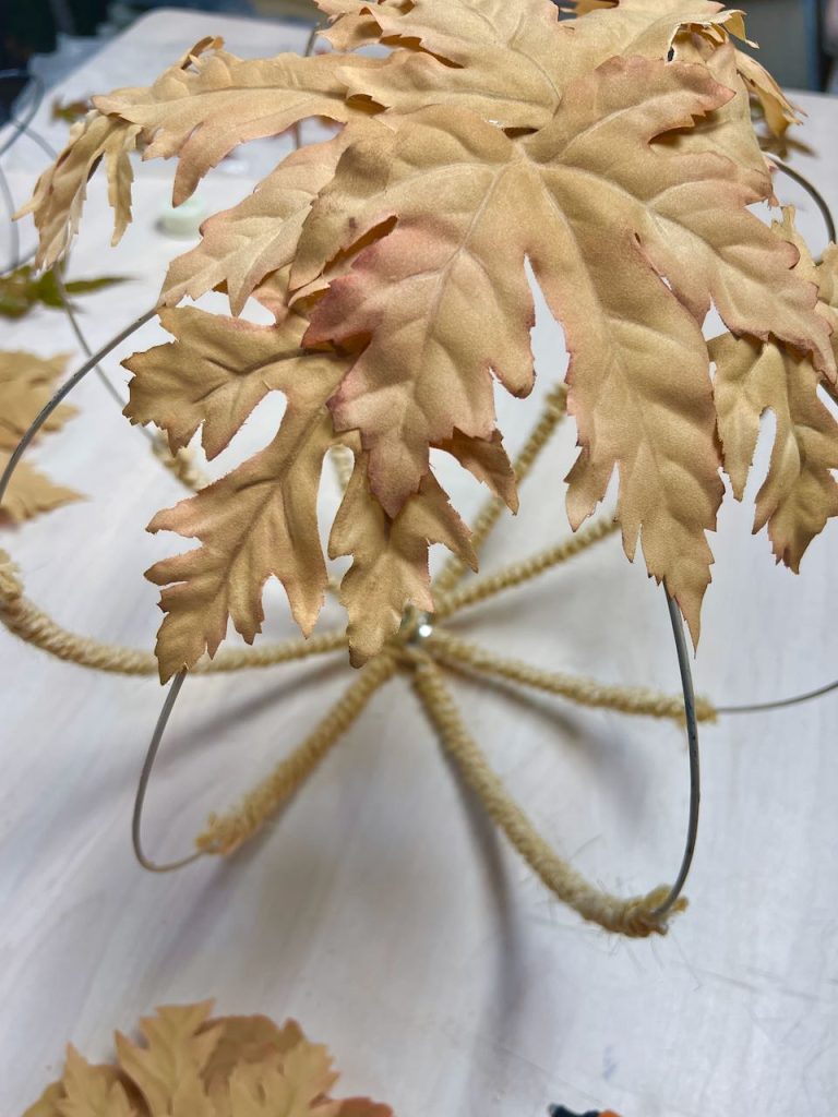 closeup of ttop of wire globe with a few leaves attachhed