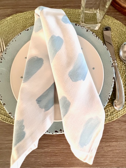 closeup of painted napkins folded on a salad plate