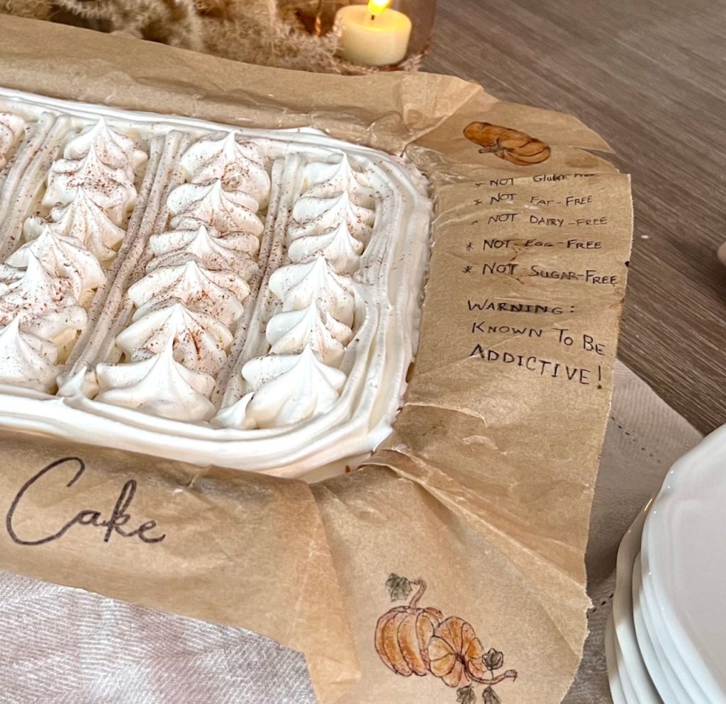 closeup of allergy info written on the parchment paper liner hanging over the edge of the baking dish