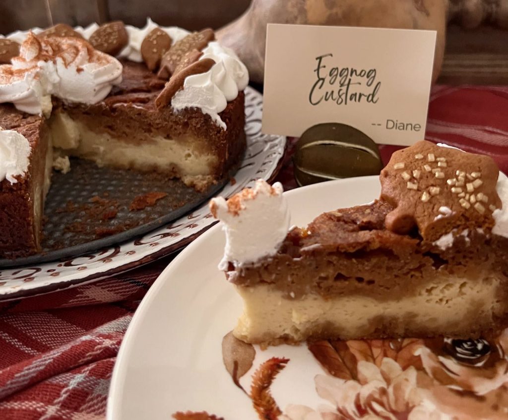 closeup of a slice of eggnog and gingerbread pie on a dessert plate next to the pie plate with the remainder of the pie