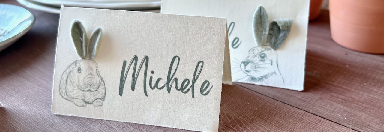 wide closeup of two placecards with bunnies whose ears are fresh lambs ear leaves