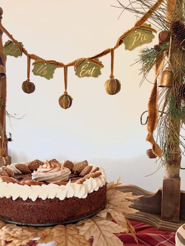 "Let Us Eat Pie" garland above a pie on a cake stand