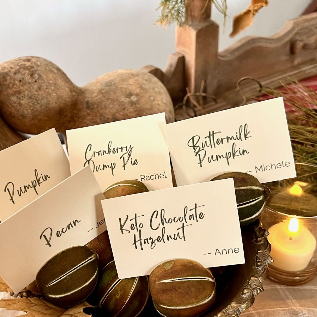 close up of a bowl of dried limes holding cards with different pie names