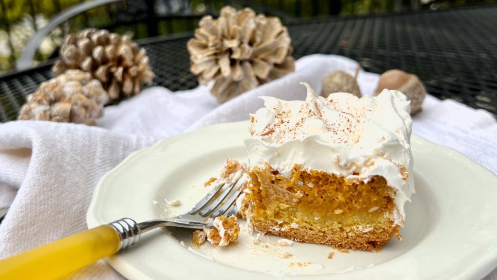 Closeup of a piece of Pumpkin Gooey Butter Cake on plate withh a fork