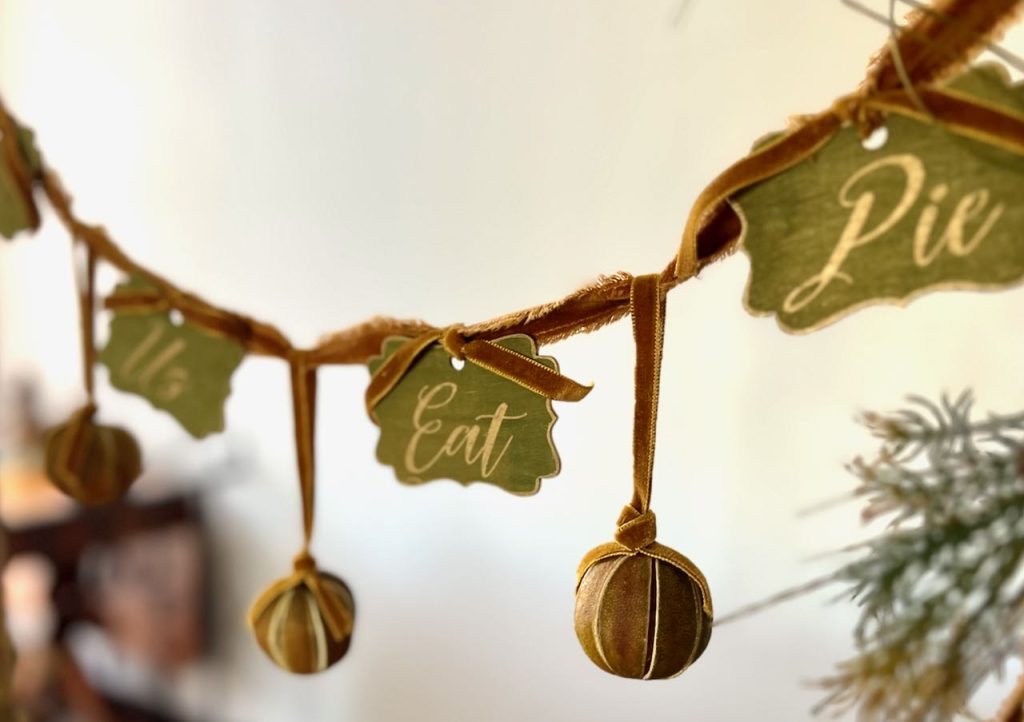 closeup of dired limes hanging with the signs on the Let Us Eat Pie garland