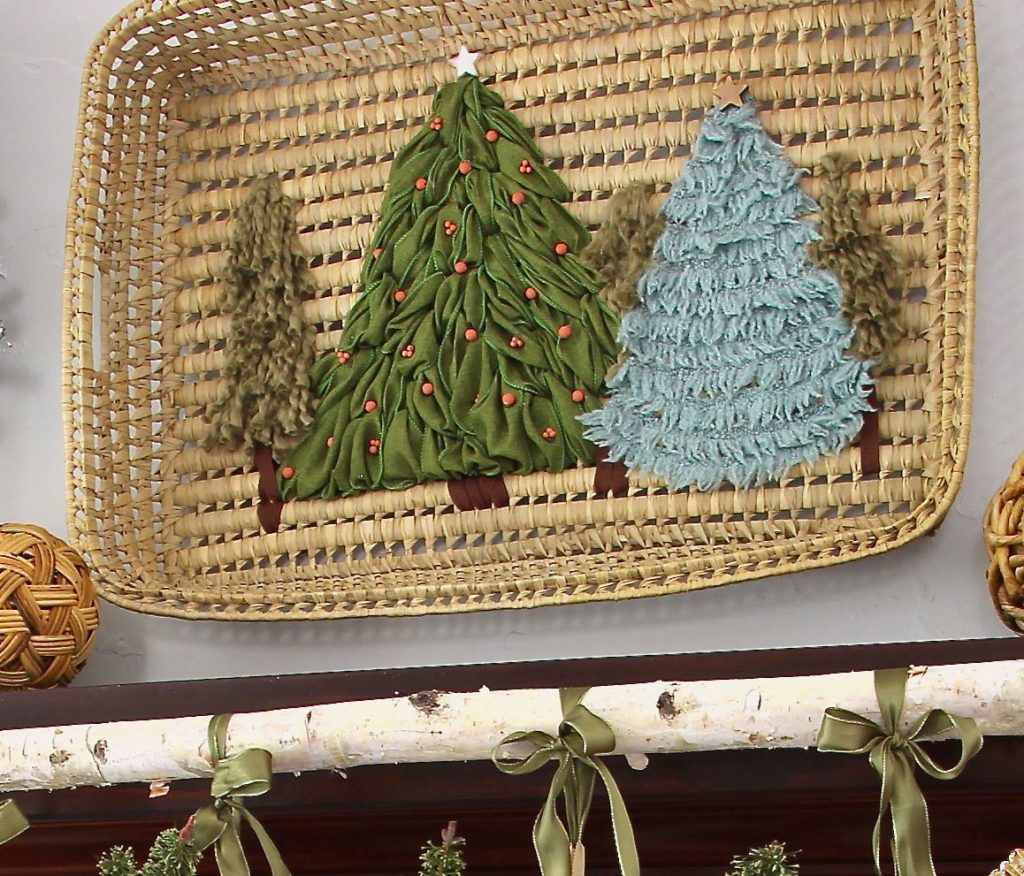 Christmas tree in a forest is embroidered with ribbon and yarn to the inside of a large basket tray