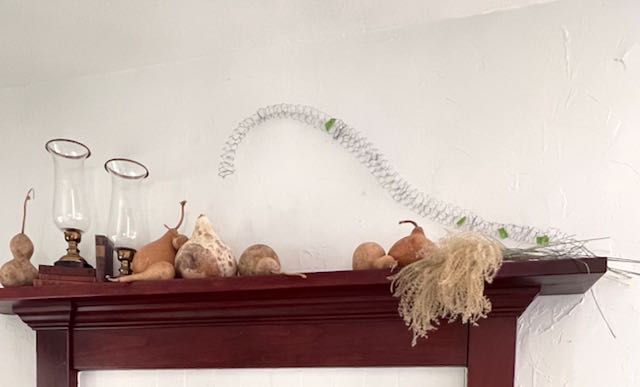 a thin tube of chicken wire is curving over the fireplace mantel