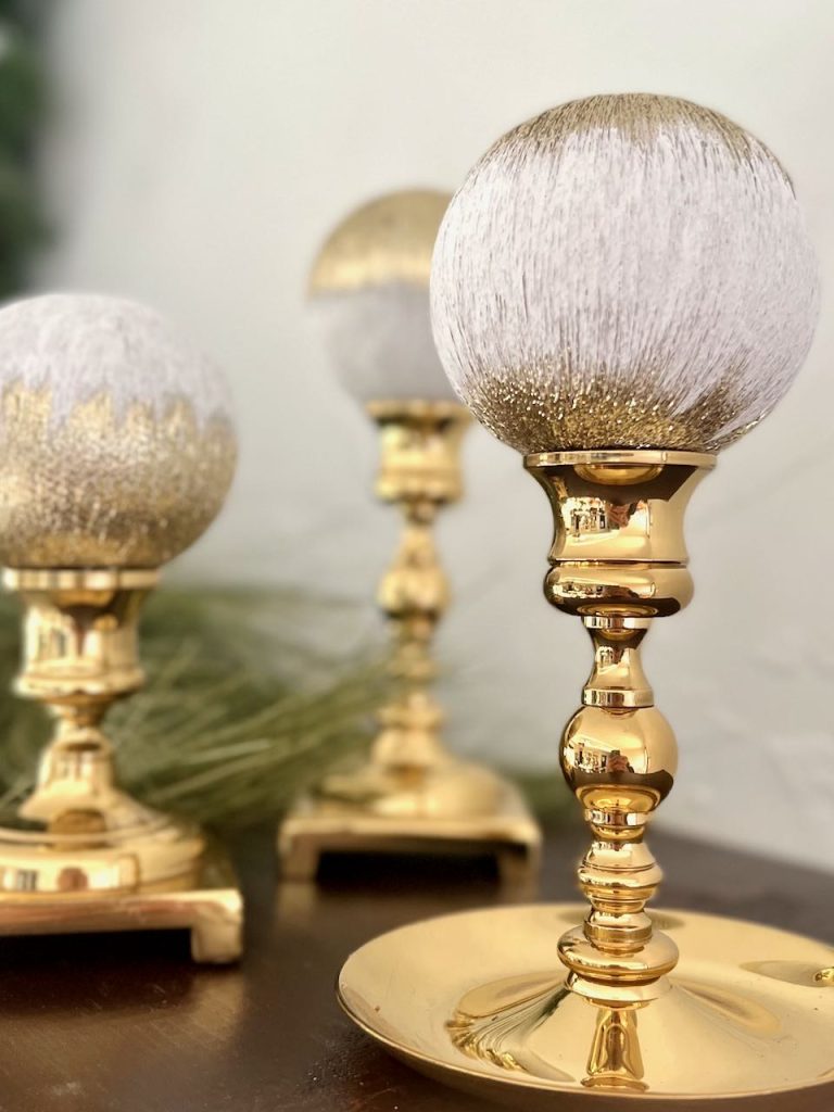 3 outdated string ornaments are revived and displayed on brass candlesticks