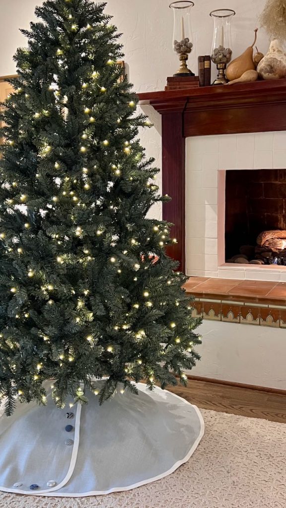 Christmas tree lit with tree skirt in place ready to be decorated