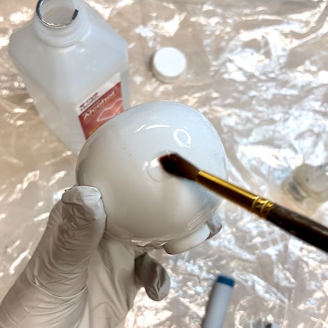 closeup of adding isopropyl alcohol on test bulb 