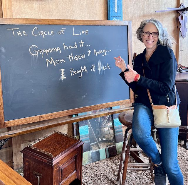 woman pointing at a chalkboard sign