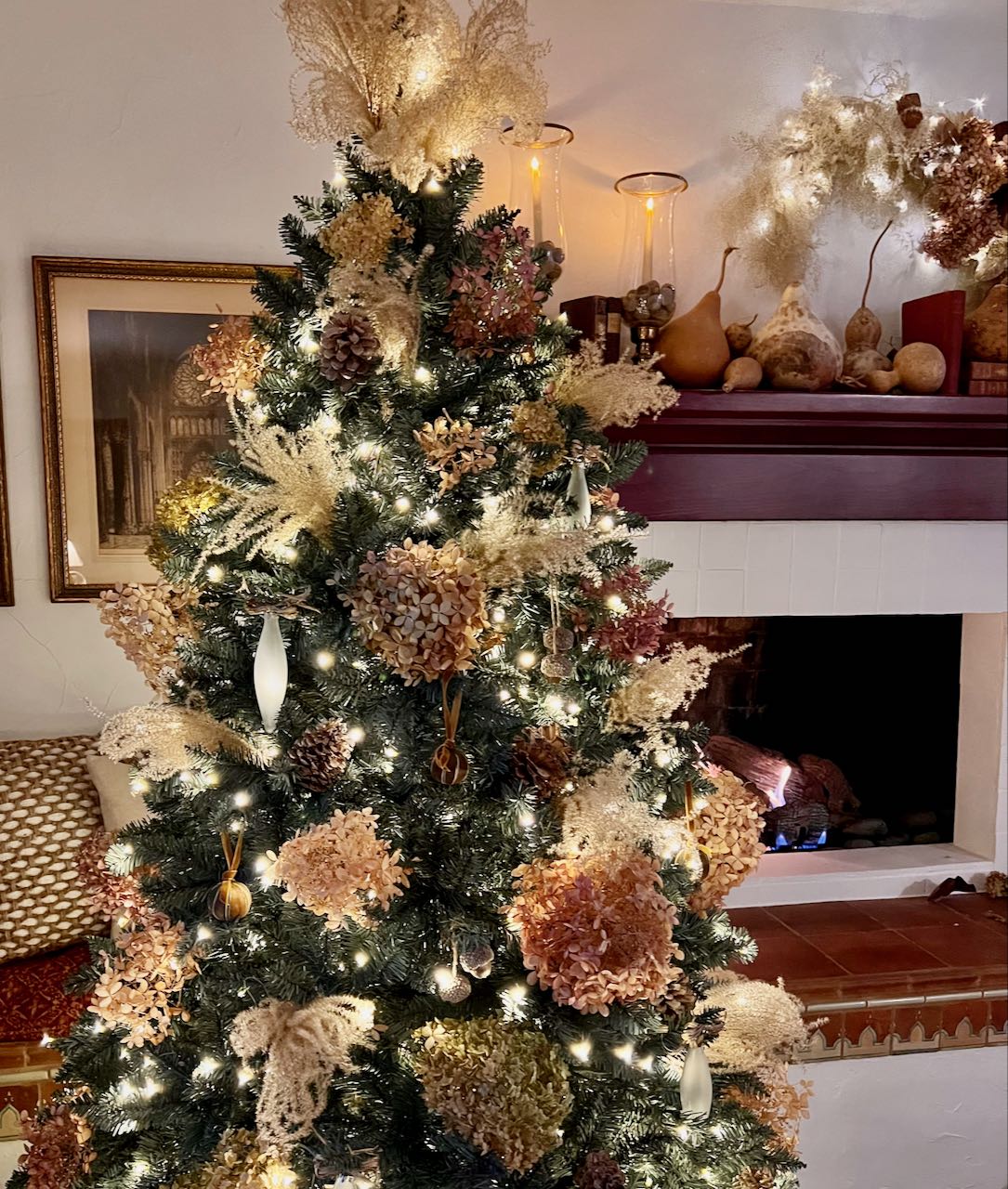 Christmas tree decorated with natural elements like the wall arrangement behind it