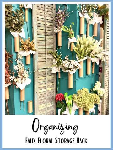 bundles of faux flowers are stored on the side off a large painted HVAC system