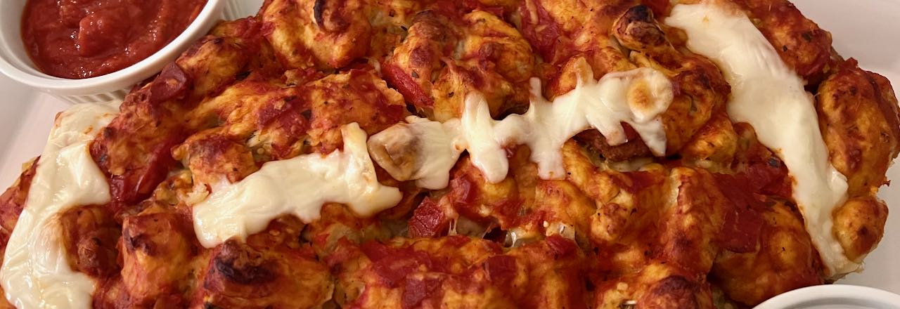 wide super closeup of football shaped pull apart pizza