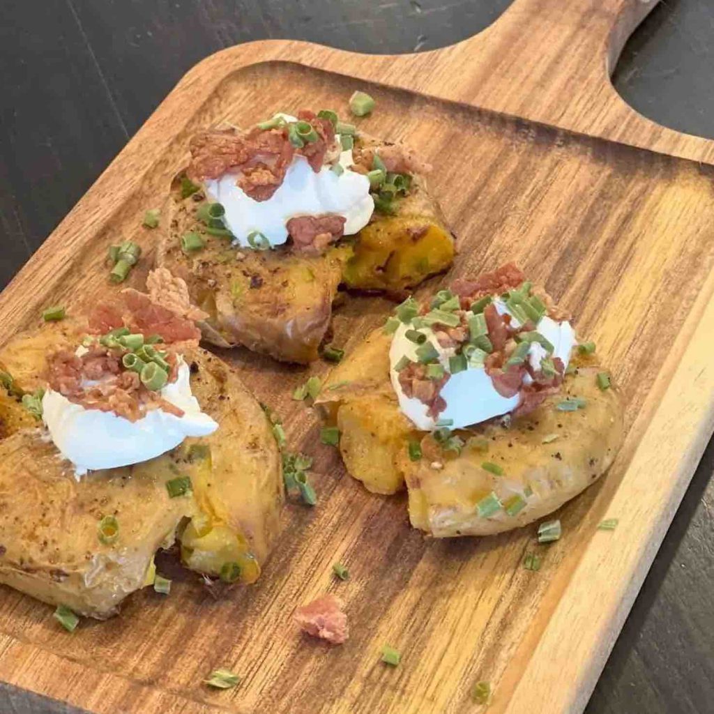 smashed potatoes on a bread board